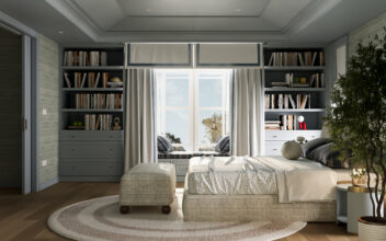 Phòng ngủ chính với giường, ghế đôn, ghế ngồi cạnh cửa sổ và kệ sách hai bên. / Master bedroom featuring a bed, ottoman, window seat, and built-in bookshelves on both sides.